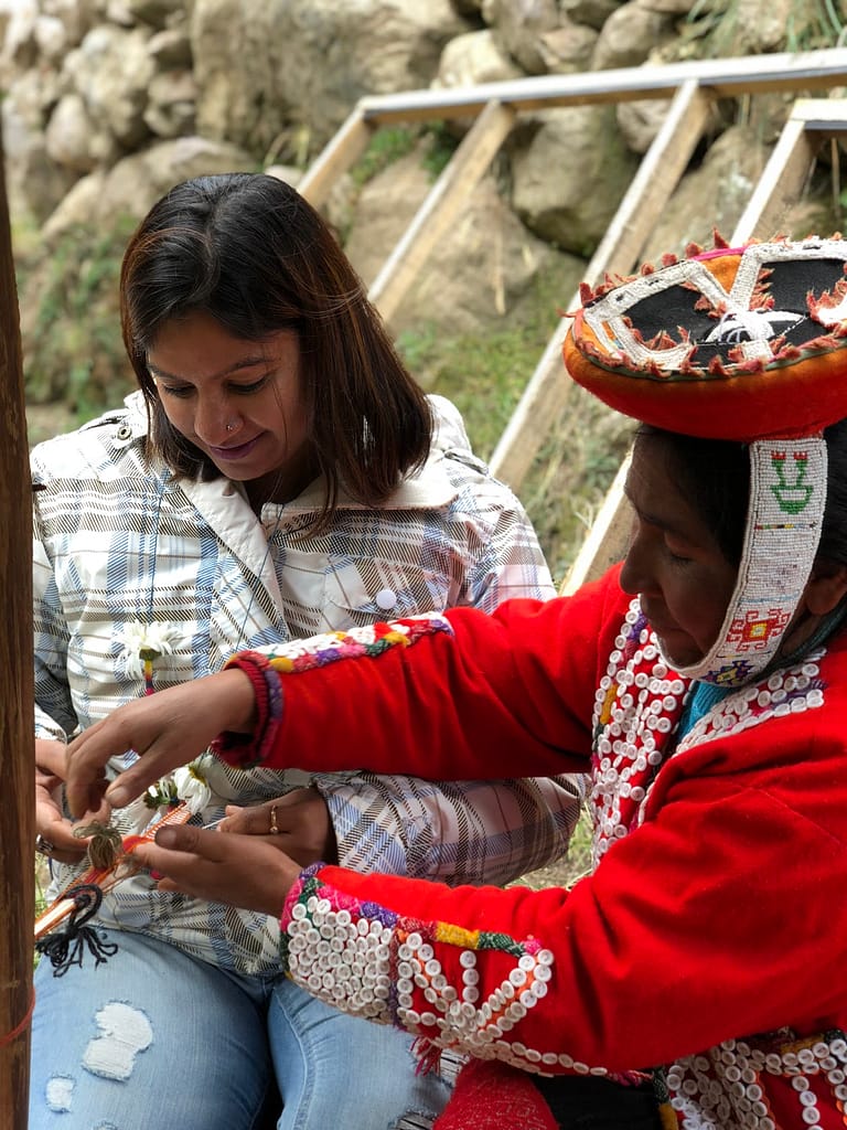 Ruchi experiencing Quechua culture learning to weave a bracelet