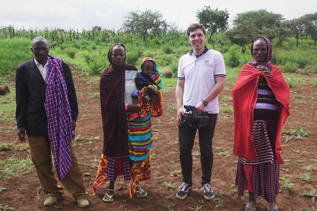 Tommy with the Enjoro village leader and two mothers. In collaboration with FAE, they are working to bring a small health clinic to Enjoro so that women don't have to travel 90+ minutes on a dirt road to give birth in a safe facility.