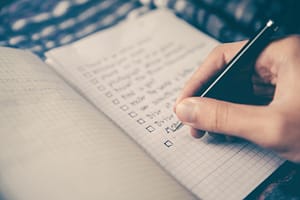 Writing SMART goals in notebook
