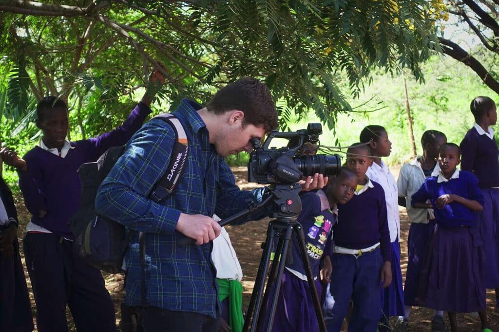 Students observe curiously while Tommy is filming at Enjoro Village Primary School, Tanzania.