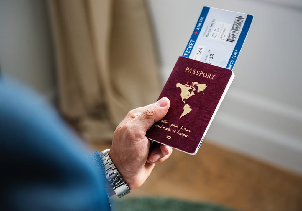 Man holding Passport - MovingWorlds Travel Checklist