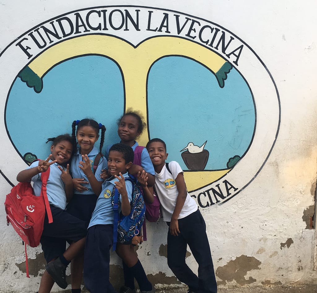 Kids 3rd grade in front of La Vecina logo