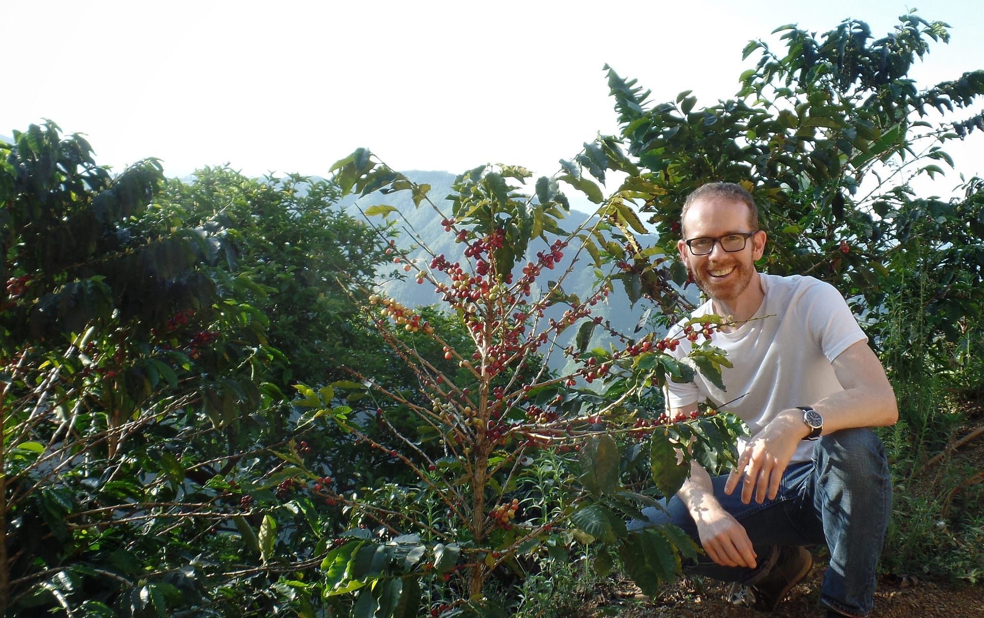 Jason with a coffee plant in Colombia