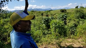A Smart Hydro Power employee examining an irrigation project.