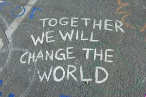 together we will change the world chalk writing