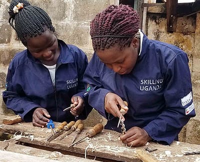 Women learning carpentry through a Safeplan Uganda skills training course