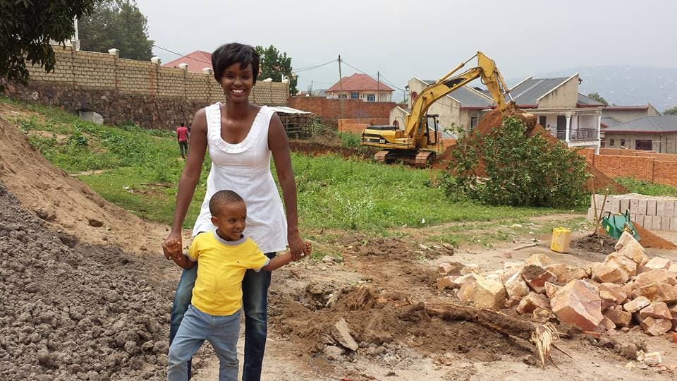 Alpha Akariza, the founder of Discovery Preschool, a new preschool in the Kigali neighborhood of Gisozi, visits the school construction site with her son. 